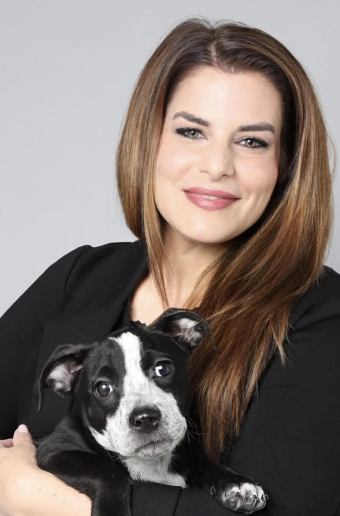 alexis holding a black and white puppy