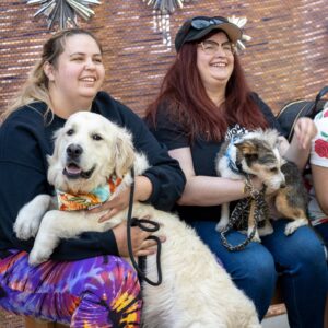 Two dogs sit in owners' laps at the Gateway.