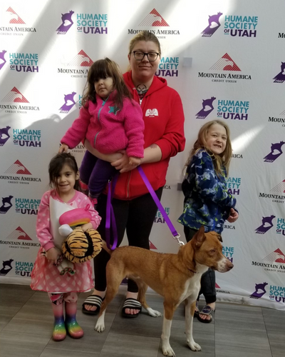 An family with three young girls pose with newly adopted dog during Fall in Love Adoption Event. 