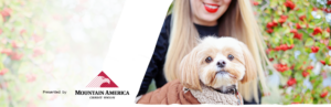 woman with red lips holding a fluffy maltese mix in a jacket