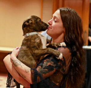 A puppy kissing a person