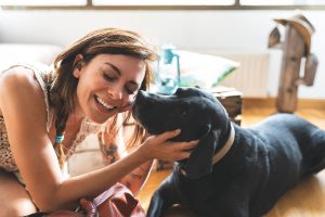 Dog kissing a lady