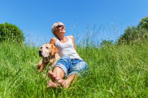 woman and dog sunbathing