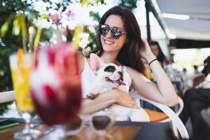 woman at a cafe with her dog